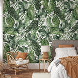 "Wall Blush's Good Vibes Wallpaper creating a serene ambiance in a modern bedroom focusing on the lush greenery design."