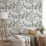 "Hera (Blue) Wallpaper by Wall Blush adorning a serene bedroom, highlighting elegant peacock design and floral patterns."