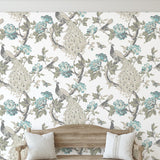 Hera (Blue) Wallpaper from Wall Blush SG02 in a cozy living room, highlighting the elegant peacock design.
