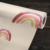 "Follow Your Dreams Wallpaper by Wall Blush with rainbow patterns, ideal for room decor, lying on a wooden surface."