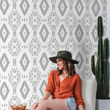 Woman in casual wear enjoying the stylish YEEHAWT (Light) Wallpaper by The MB Line in a cozy living room.

(Note: This alt text is crafted to be descriptive and include the product title, brand, and type of room while focusing on the wallpaper. The presence of the person is mentioned to give context to the setting, but the wallpaper remains the focal point of the description.)
