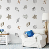 "Wall Blush Nautilus Wallpaper in a coastal-style living room highlighting marine elements."
