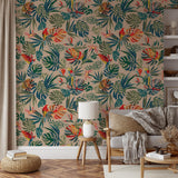 "Wall Blush's Macaw Wallpaper vividly accentuates a cozy living room, showcasing tropical style and vivid hues."