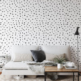 "Modern bedroom featuring Wall Blush's PERIOD. Wallpaper with stylish dot pattern, emphasizing chic interior design."