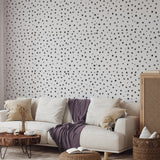 Chic living room featuring The MB Line's PERIOD. Wallpaper with elegant black dots design.
