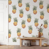 Tropic Like It's Hot Wallpaper by Wall Blush in a stylish living room, focus on vibrant pineapple design.