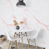 "Ethereal Wallpaper by Wall Blush in a modern dining room, showcasing elegant pink marble design focus."