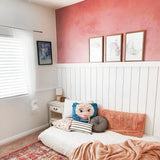 Wall Blush Rosemary Wallpaper featured in cozy bedroom decor with a focus on the textured pink accent wall.
