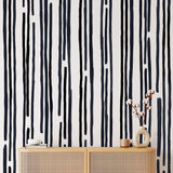 Stripped by Spencer Wallpaper from The Tamra Judge Line installed in a modern living room, focusing on wall detail.
