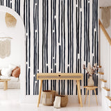 "Stripped by Spencer Wallpaper by Wall Blush in a modern living room, accentuating the space with bold stripes."