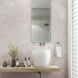 Making Me Blush Wallpaper from The Kail Lowry Line featured in elegant bathroom setting with vanity.
