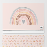 Wall Blush's Eden's Rainbows Wallpaper in a pink nursery room, showcasing playful rainbow patterns.

