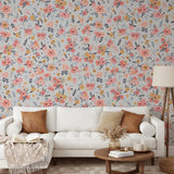 "Wall Blush's In Bloom (Silver) Wallpaper featured in a cozy living room, highlighting the vibrant floral design."