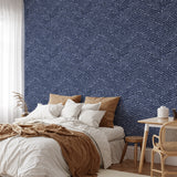 "Windsor Wallpaper by Wall Blush in Stylish Bedroom, Focus on Navy Herringbone Pattern."
