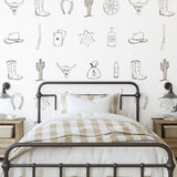 Outlaw (Brown) Wallpaper by Wall Blush SG02 in a stylish bedroom with Western-themed decor and accents.
