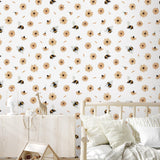 Alt: Wall Blush's Bumble (White) Wallpaper featuring bees and flowers adorns a cozy, children's bedroom, highlighting the wall decor.

