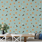 Bumble (Blue) Wallpaper by Wall Blush in cozy dining area, highlighting bee and daisy design focus.
