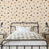 Bumble (Tan) Wallpaper by Wall Blush in cozy bedroom, with focus on the floral and bee design.
