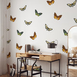 Alt: "Wall Blush's Flutter Wallpaper displayed in a modern home office, with vivid butterfly patterns enhancing the decor."