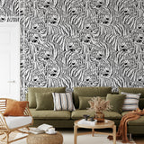 "Raja Wallpaper by Wall Blush featuring bold tiger design in cozy living room with olive green sofa."