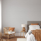 "Wall Blush's Carefree (Grey) Wallpaper featured in a stylish, cozy bedroom setting, highlighting the elegant wall decor."
