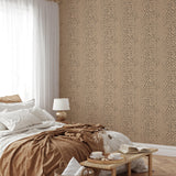 "Charlie Wallpaper by Wall Blush enhancing bedroom decor with modern speckled design, cozy bedding accents."