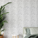 Charlie Black and White Wallpaper from The Chelsea DeBoer Line in a modern bedroom, creating a stylish focal point.
