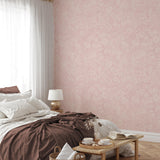 "Charlotte's Chantilly Wallpaper by Wall Blush adorns a cozy bedroom, highlighting elegant floral design."