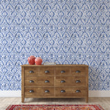 "Wall Blush's Francesca Wallpaper featured in a living room setting, highlighting the intricate blue pattern design."