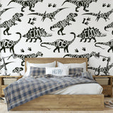 Dino Rush Wallpaper by Wall Blush in a cozy bedroom, highlighting the playful dinosaur pattern focus.
