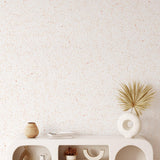 Earthy Terrazzo Wallpaper from The Minty Line enhancing a modern living room's aesthetic.

