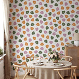 "Wall Blush's Let's Hang Wallpaper in a stylish dining room with a focus on colorful patterned design."