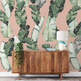 "Haleiwa Wallpaper by Wall Blush in stylish living room, with focus on tropical patterned accent wall."