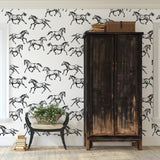"Spirit Wallpaper by Wall Blush in a stylish living room, showcasing elegant horse patterns as the focal point."