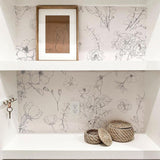 "Lined Meadow Wallpaper by Wall Blush featured in elegant bathroom nook with floral design focus."