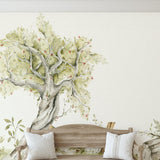 Wall Blush SG02 Glade Wallpaper featured in cozy living room with rustic wooden bench and tree motif.
