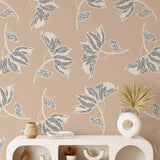 Leah Wallpaper by Wall Blush in a stylish living room, showcasing leaf patterns and neutral tones.

