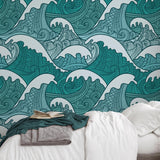 Stylish bedroom featuring Wall Blush's Maui Wallpaper with intricate teal wave patterns on the accent wall.
