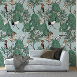 Wall Blush Mangrove Wallpaper in a stylish living room with modern couch and bookshelf.
