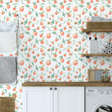 "Peachy Clean Wallpaper by Wall Blush featured in stylish laundry room, highlighting playful peach pattern design."