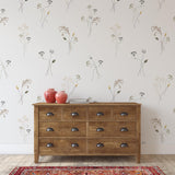 "Prairie Wallpaper by Wall Blush featured in a modern bedroom with rustic dresser and vibrant rug."