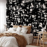 Wall Blush Mirage Wallpaper feature in modern bedroom, stylish abstract design, cozy bed furnishings focus.