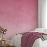 "Wall Blush's Rosemary Wallpaper in bedroom, cozy decor with pink textured wall focus, modern design."