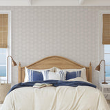 Wall Blush's Sand Dollar Wallpaper in a coastal bedroom setting, highlighting the elegance and serene design.
