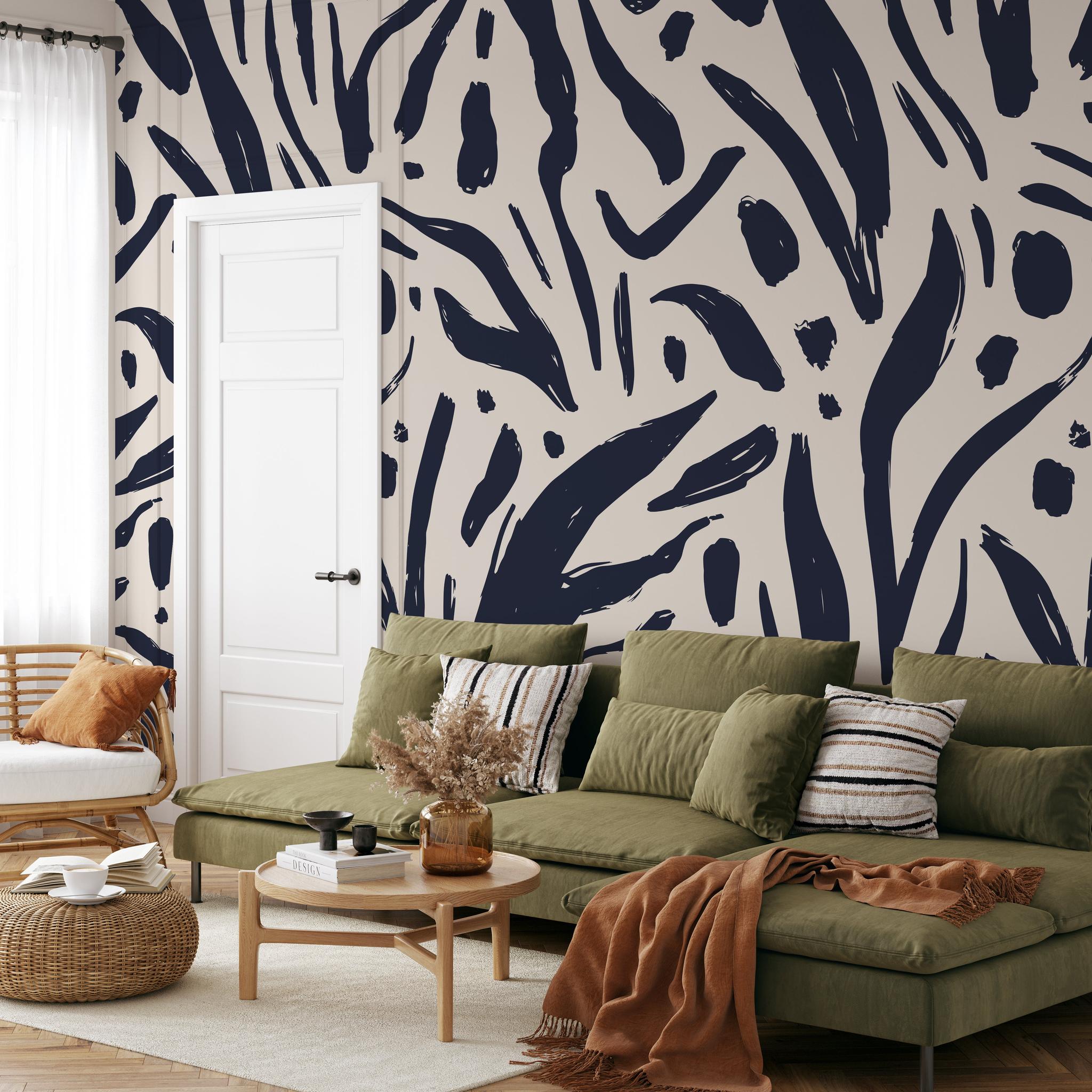 "Wall Blush Signe Wallpaper featured in stylish living room with green sofa and modern decor."
