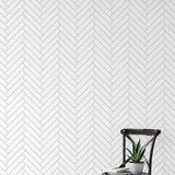 Stitch Wallpaper by Wall Blush in a minimalist living room, enhancing a serene ambiance with a herringbone pattern.
