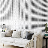 "The Tara Wallpaper by Wall Blush on living room wall behind white couch with modern decor"