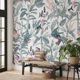 Alt: "Wall Blush Tropics Wallpaper enhancing a cozy living room ambiance with vibrant botanical patterns."